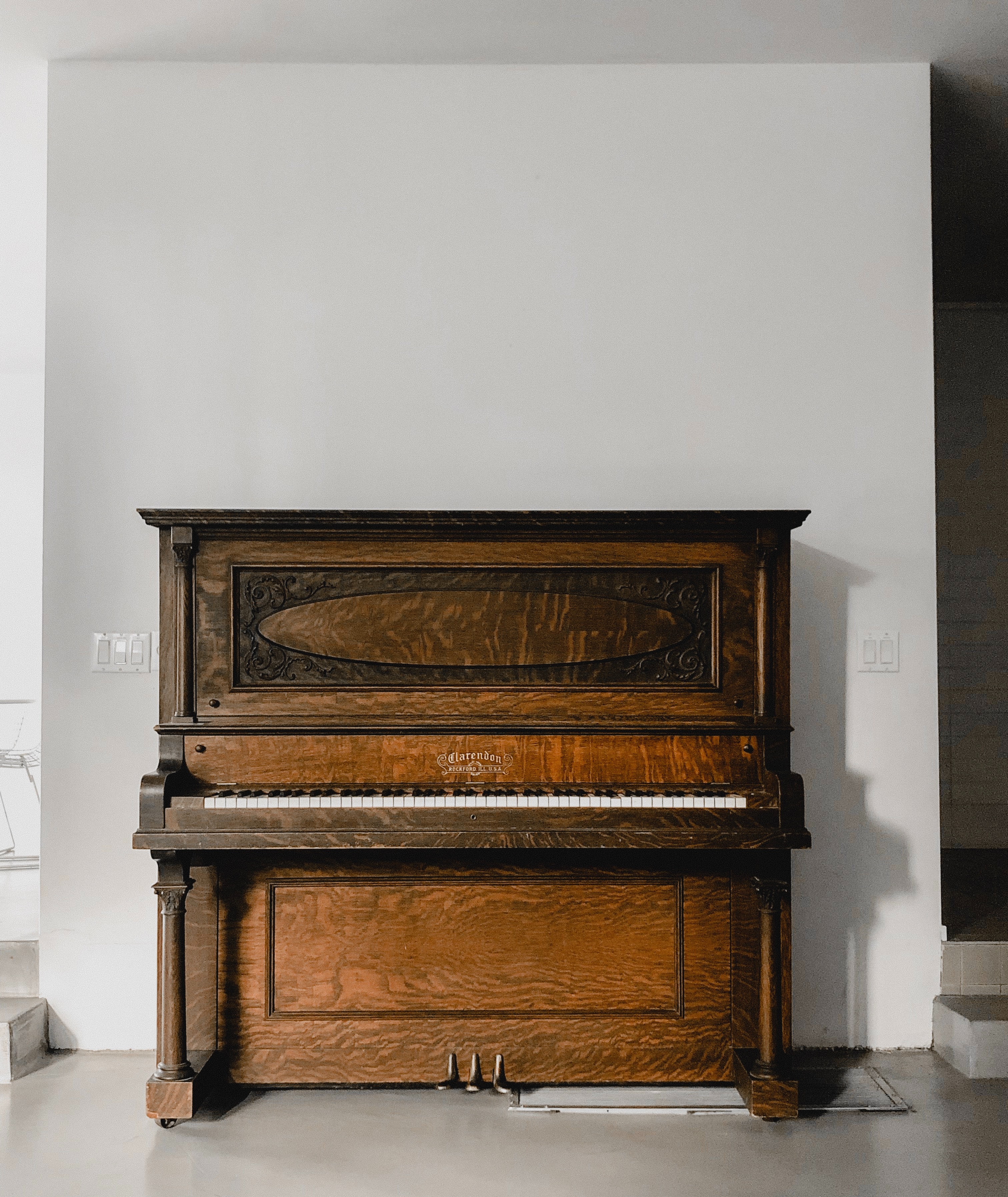Piano sitting against white wall