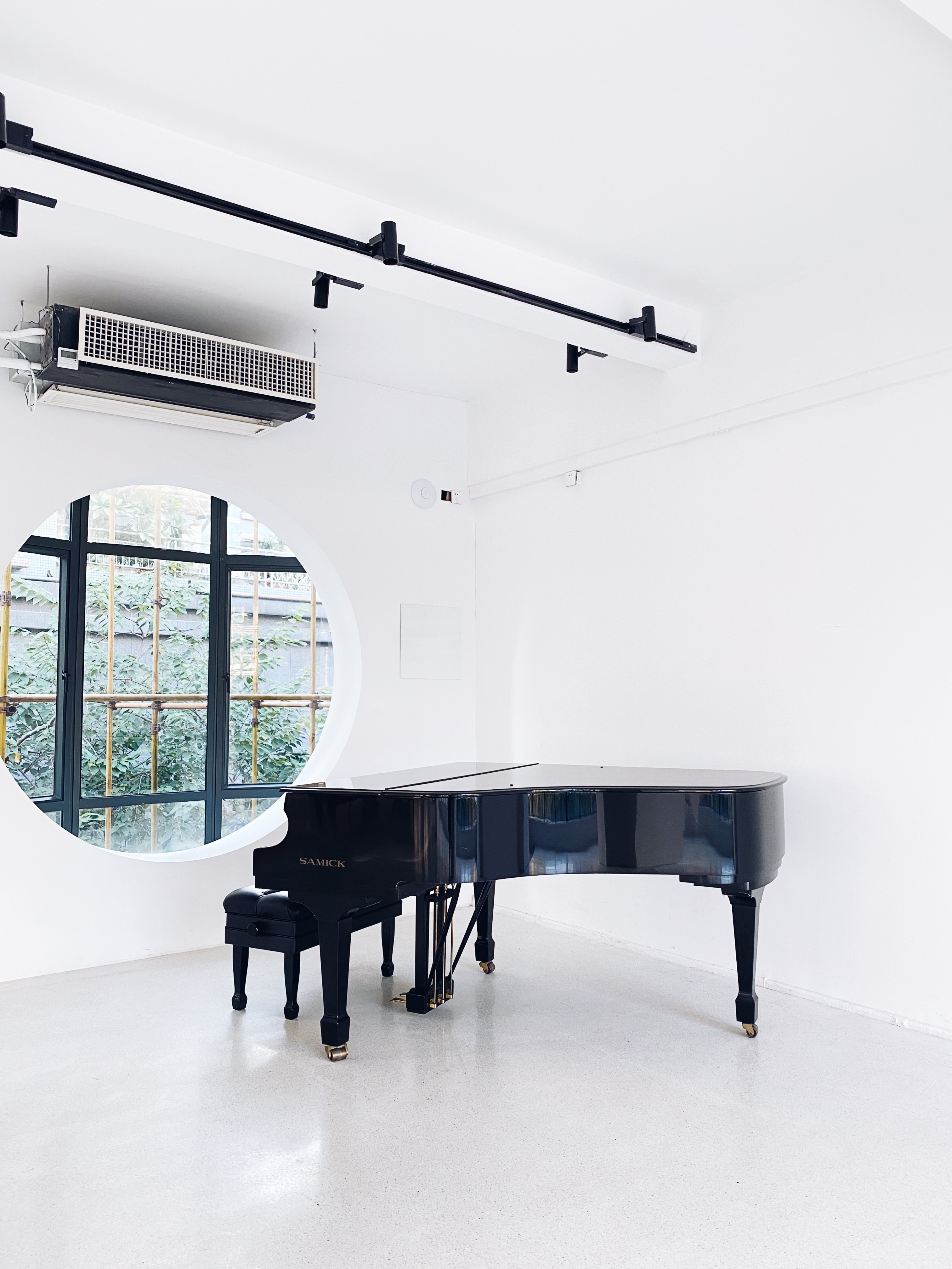 Piano in large white room