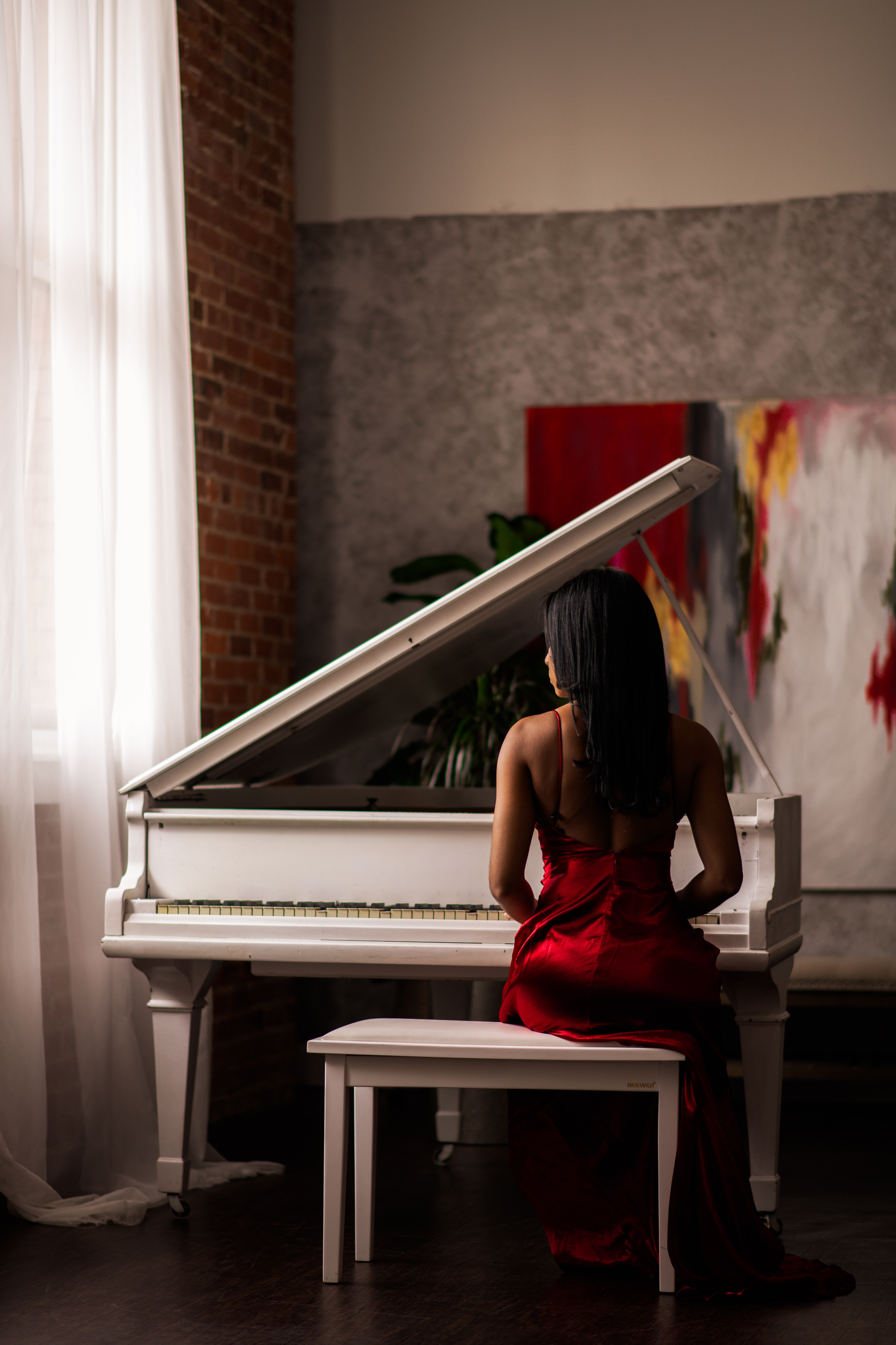 Woman in dress sitting at piano
